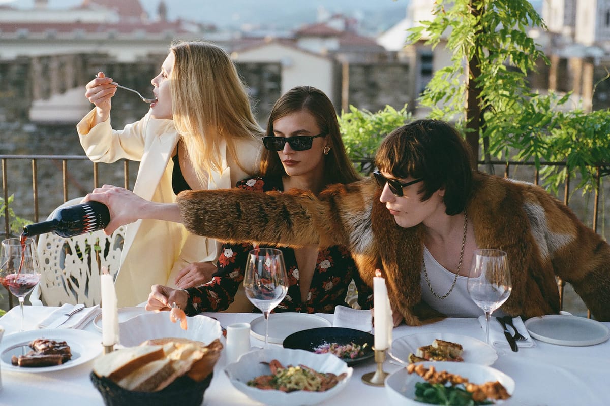 Young people sitting at a table for lunch together on the terrace