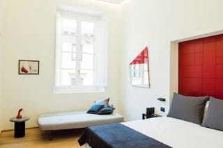 Deluxe room detail with double bed and sofa bed