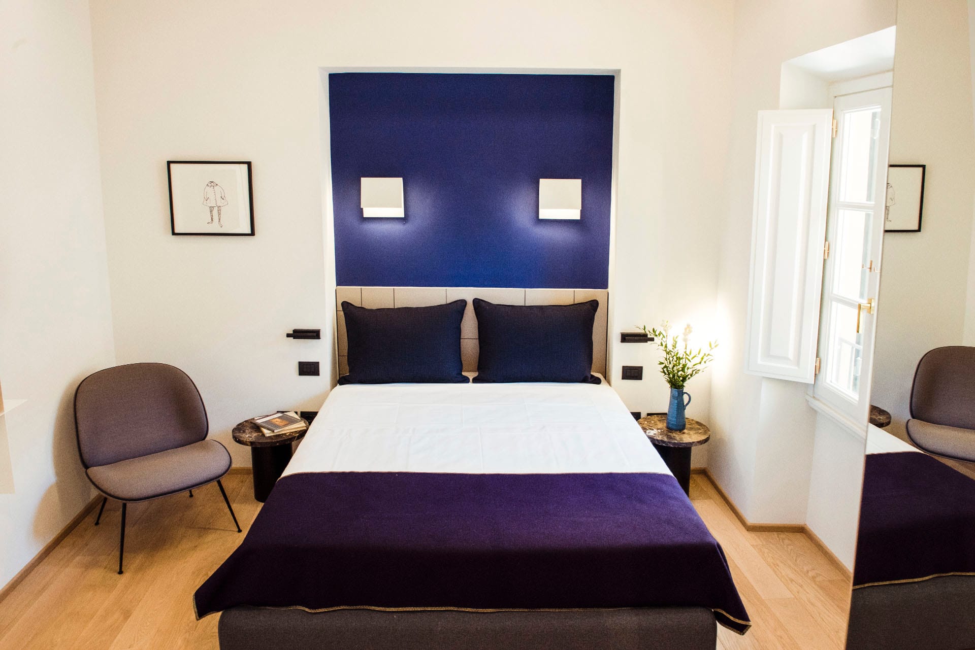 Superior room with double bed and purple sheets